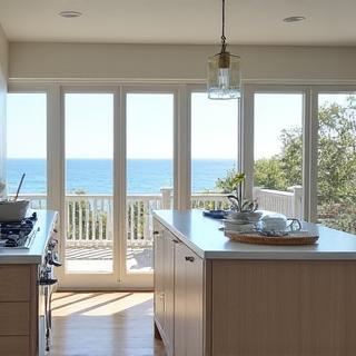 Bright kitchen with large windows and coastal decor, from a Coastal Cottage project