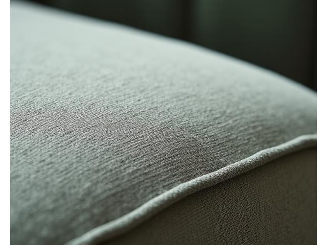 Close-up of a luxurious upholstered sofa fabric, highlighting texture and quality stitching.